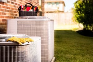 a pair of gloves on a air conditioner